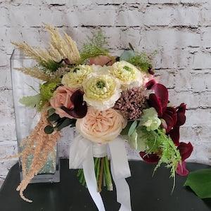Wine Brides bouquet with Real touch orchids, ferns and eucalyptus. White roses, light blush Ranunculus and cabbage roses with pampas grass. - Flowerhint